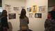 Guests at the opening reception look at Guerrilla Girls posters.